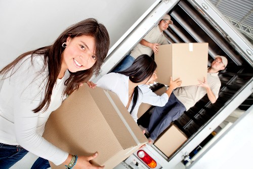 Packed household boxes and furniture ready for transport during a Maidavale move
